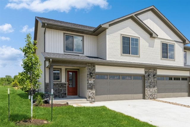 view of front of property featuring a garage and a front lawn