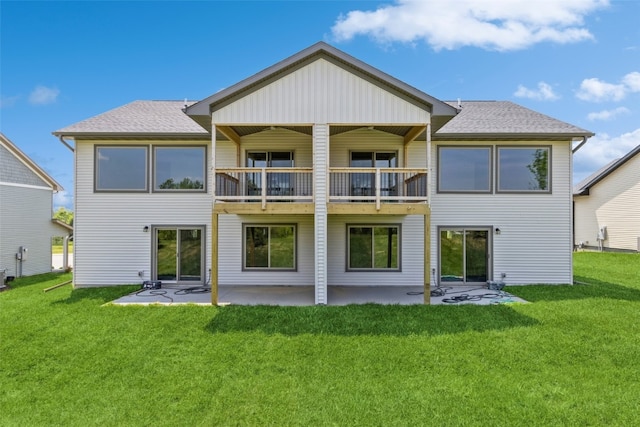 rear view of house with a lawn and a patio area