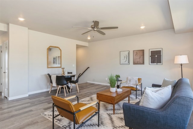 living room featuring hardwood / wood-style floors and ceiling fan