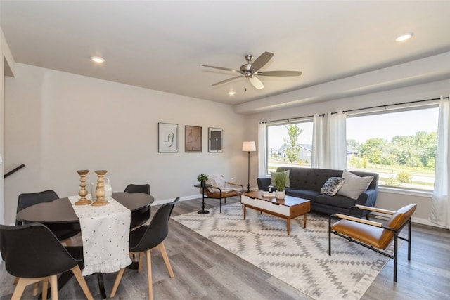 living room featuring hardwood / wood-style floors and ceiling fan