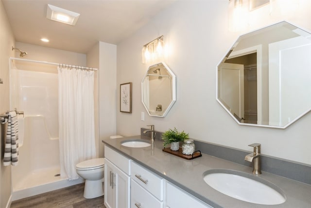 bathroom with vanity, toilet, a shower with curtain, and hardwood / wood-style floors