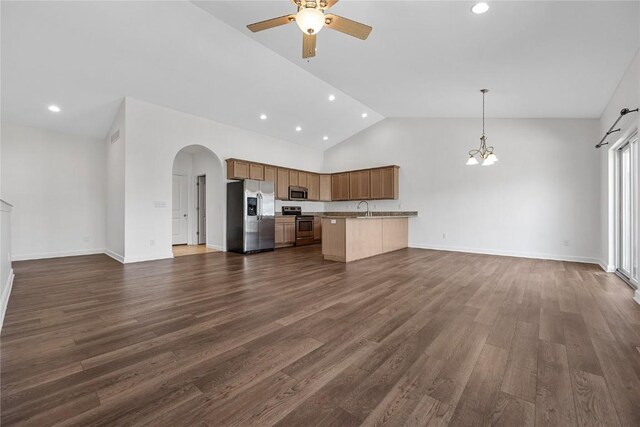 unfurnished living room featuring sink, high vaulted ceiling, ceiling fan with notable chandelier, and dark hardwood / wood-style floors