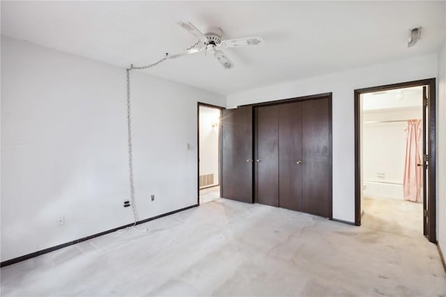 unfurnished bedroom with ceiling fan, ensuite bath, and a closet