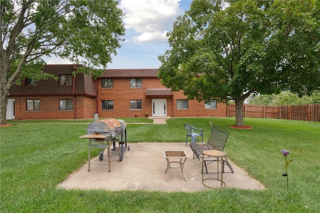 view of property's community with a yard and a patio