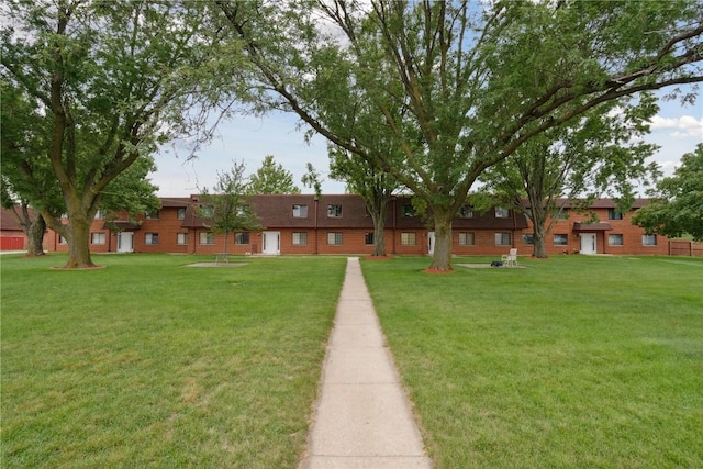 view of home's community with a yard