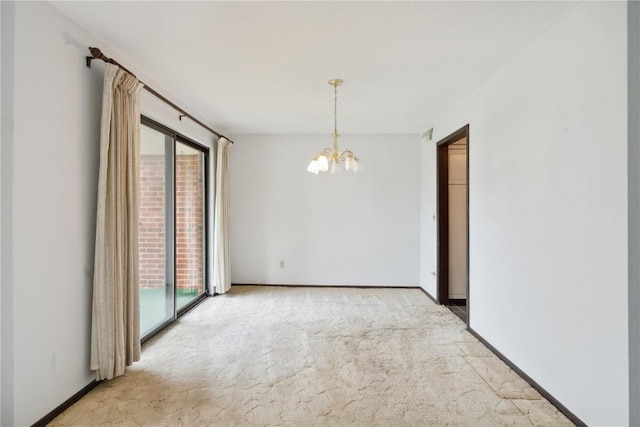 empty room with carpet floors and a chandelier