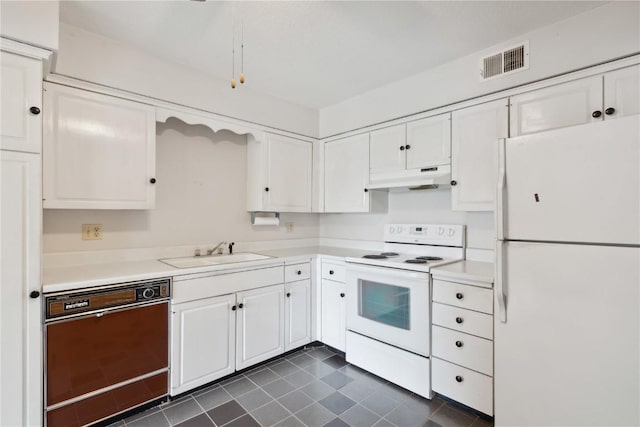 kitchen with sink, white appliances, and white cabinets