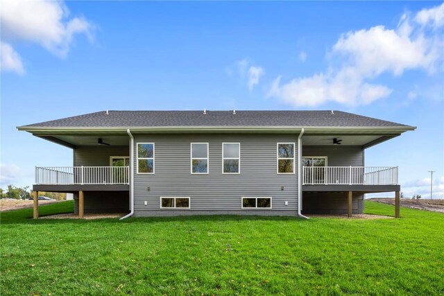 back of house featuring a yard and ceiling fan