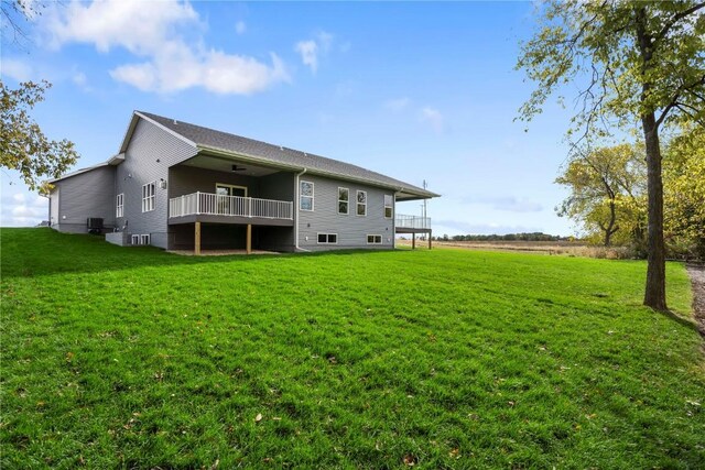 back of house with a yard and a wooden deck