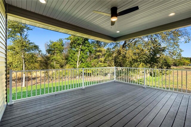 wooden terrace with ceiling fan and a lawn