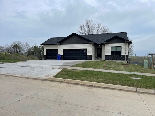 view of front of property with a garage and a front yard