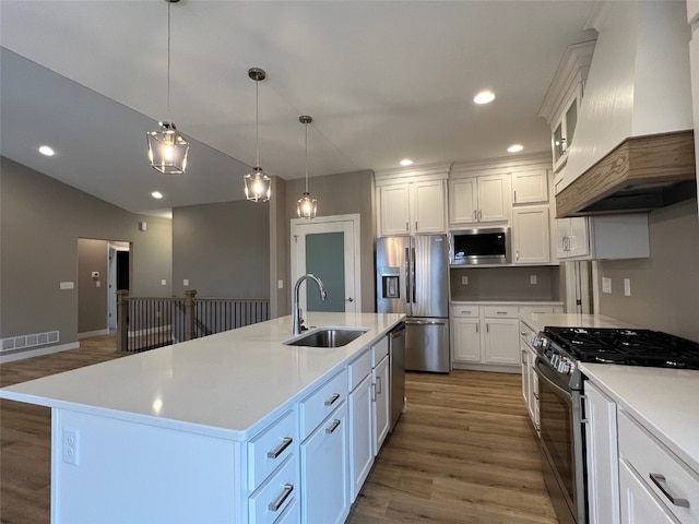 kitchen featuring sink, decorative light fixtures, a kitchen island with sink, custom exhaust hood, and appliances with stainless steel finishes