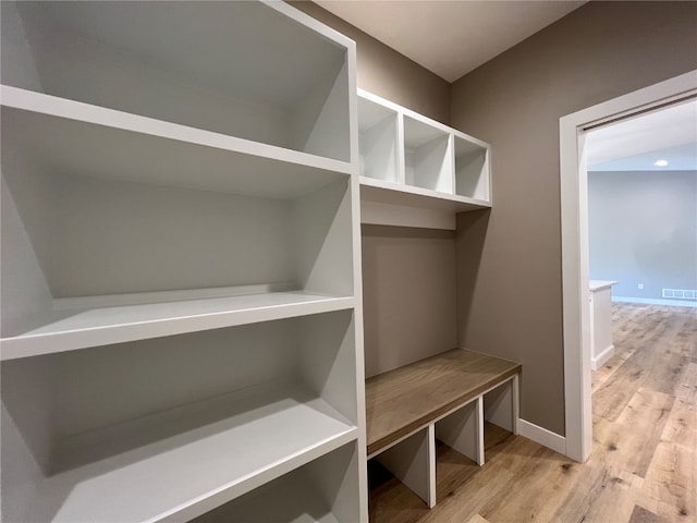 mudroom with light hardwood / wood-style floors