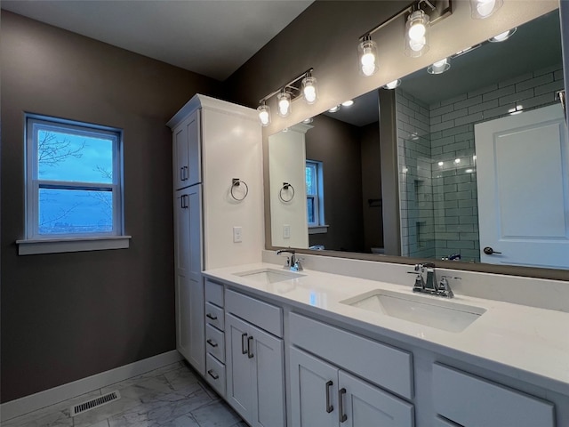 bathroom with vanity and a shower with shower door