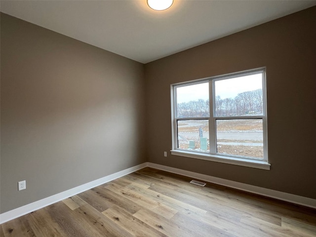 spare room with light hardwood / wood-style floors