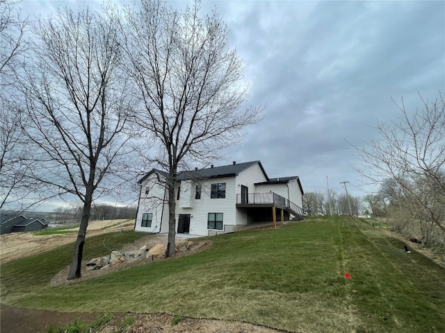 view of side of home featuring a lawn and a wooden deck