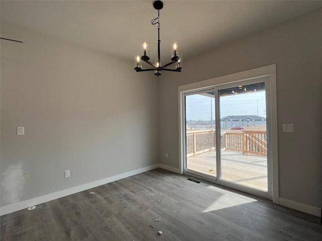 interior space featuring hardwood / wood-style floors and a chandelier