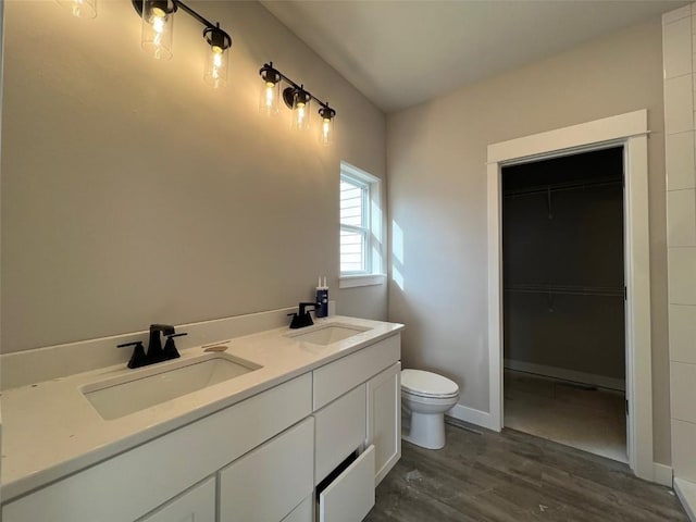 bathroom featuring vanity, hardwood / wood-style floors, and toilet