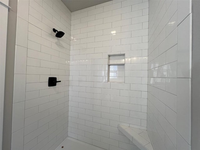 bathroom with tiled shower