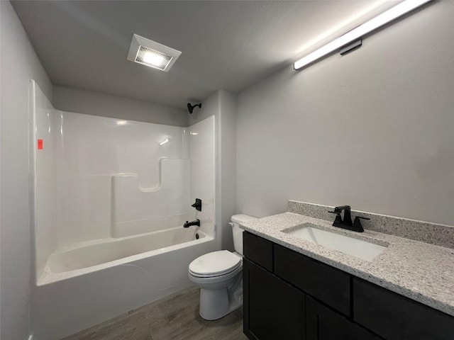 full bathroom featuring vanity, hardwood / wood-style flooring, toilet, and shower / bath combination