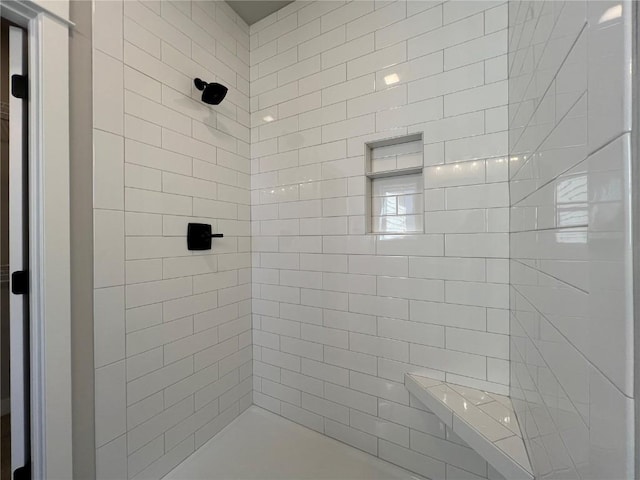 bathroom featuring a tile shower