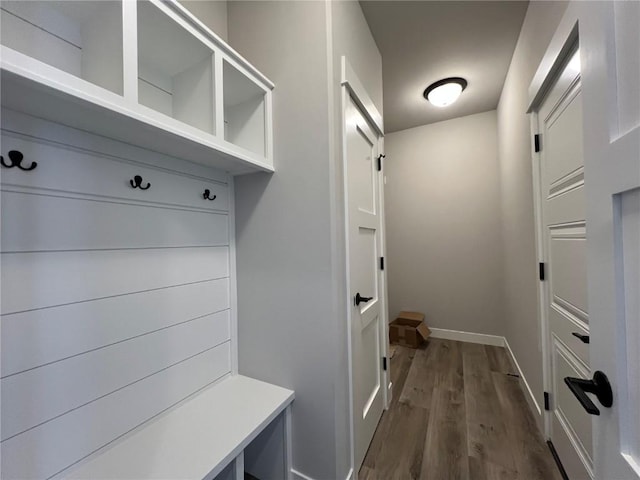 mudroom featuring dark wood-style floors and baseboards