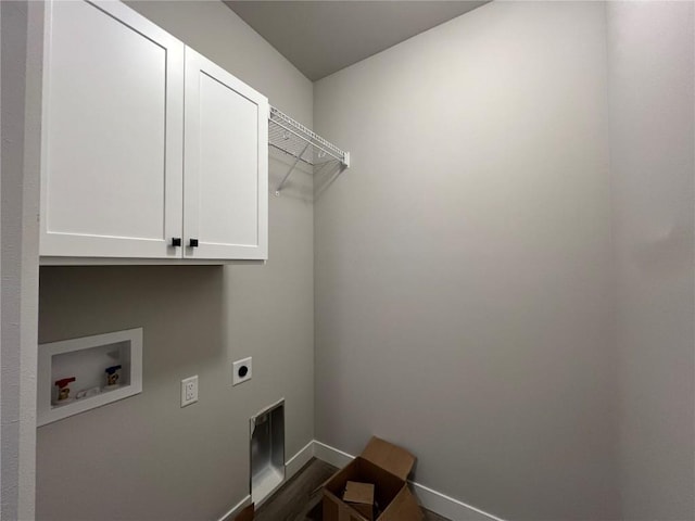 laundry room featuring cabinet space, baseboards, dark wood-style flooring, washer hookup, and electric dryer hookup