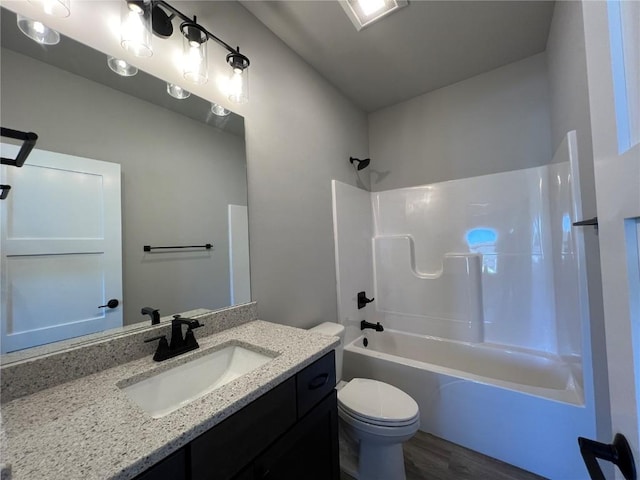 full bath featuring shower / bathing tub combination, vanity, toilet, and wood finished floors