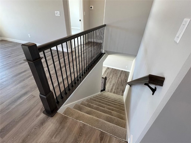 stairs featuring baseboards and wood finished floors