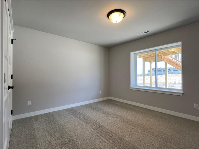 unfurnished room with carpet, baseboards, and visible vents