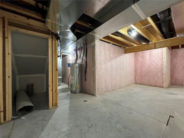 unfinished basement featuring water heater