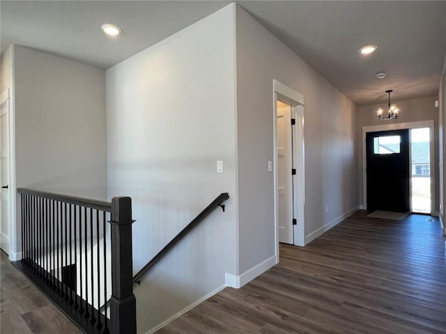 entrance foyer featuring a notable chandelier, recessed lighting, wood finished floors, and baseboards