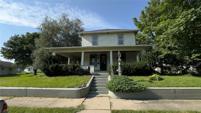 view of front of property with covered porch and a front yard