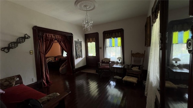 interior space with dark hardwood / wood-style floors and an inviting chandelier