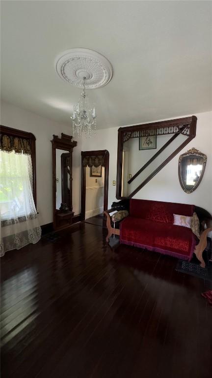 bedroom featuring an inviting chandelier and hardwood / wood-style floors