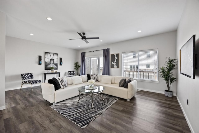 living room featuring dark hardwood / wood-style flooring and ceiling fan