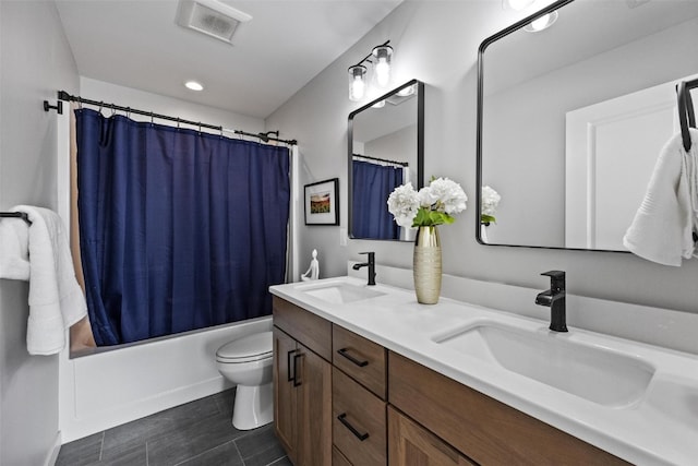 full bathroom featuring shower / bath combo, vanity, and toilet