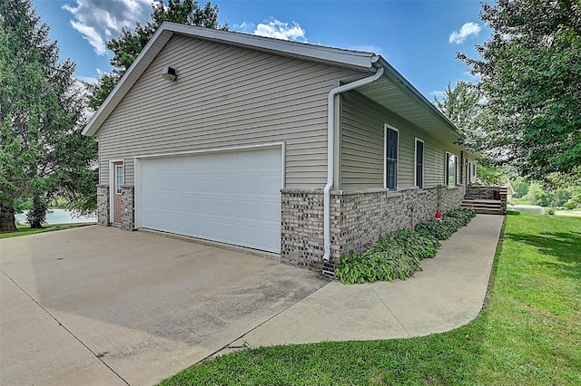 view of property exterior with a yard, stone siding, and a garage