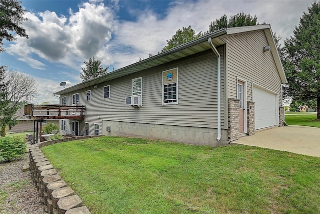 rear view of property with a lawn, cooling unit, concrete driveway, and a garage