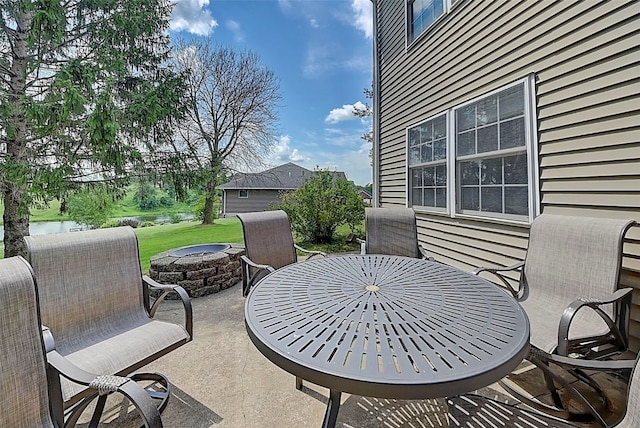 view of patio / terrace featuring outdoor dining space and an outdoor fire pit