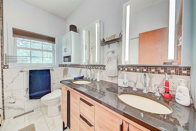 bathroom featuring toilet, visible vents, marble finish floor, and a sink