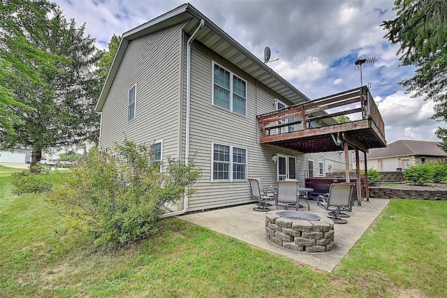 back of house with a yard, a patio, a fire pit, and a wooden deck