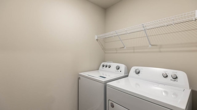 washroom with washing machine and clothes dryer