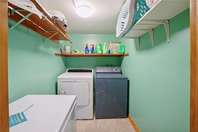 clothes washing area with light tile patterned floors and washing machine and dryer