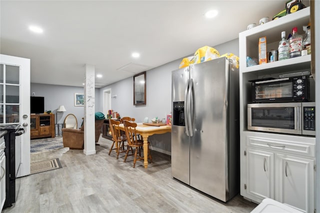 kitchen featuring light hardwood / wood-style flooring, white cabinetry, and stainless steel appliances