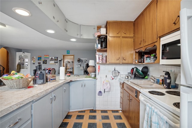 kitchen featuring decorative backsplash, white appliances, gray cabinetry, light tile patterned floors, and kitchen peninsula