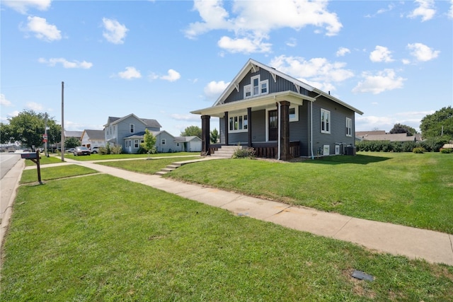 bungalow with a front yard and covered porch