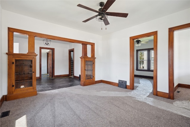 interior space with ceiling fan and dark carpet