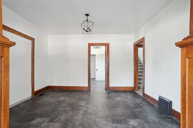 empty room featuring dark tile patterned floors