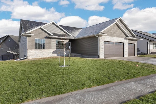 view of front of home with a garage and a front lawn